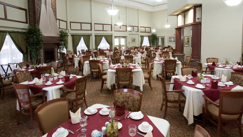 The dining room at Rutherford Heights retirement home with tables, chairs, and tablecloths