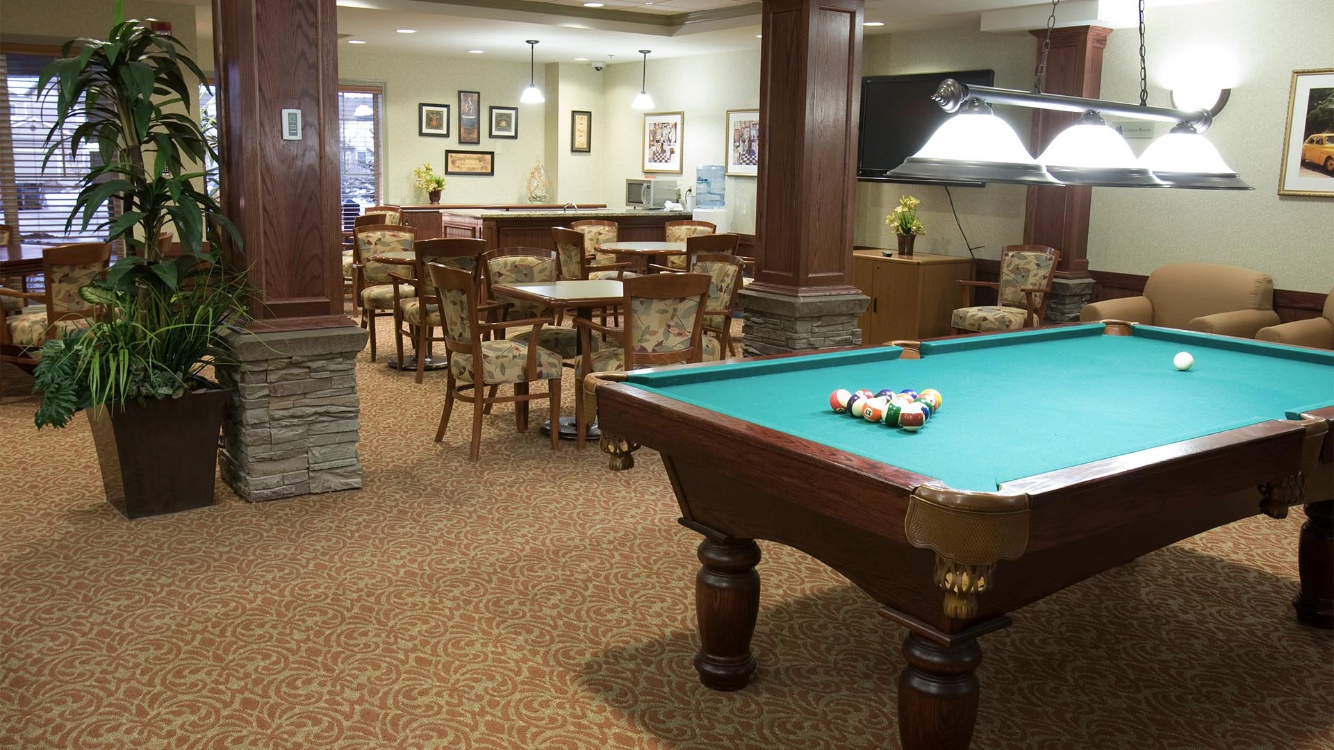 The pool table and card tables in the Rutherford Heights senior living games room